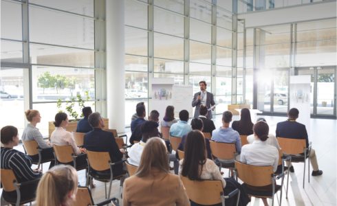 business-people-listening-to-businessman-and-raisi-2023-11-27-05-10-17-utc 1